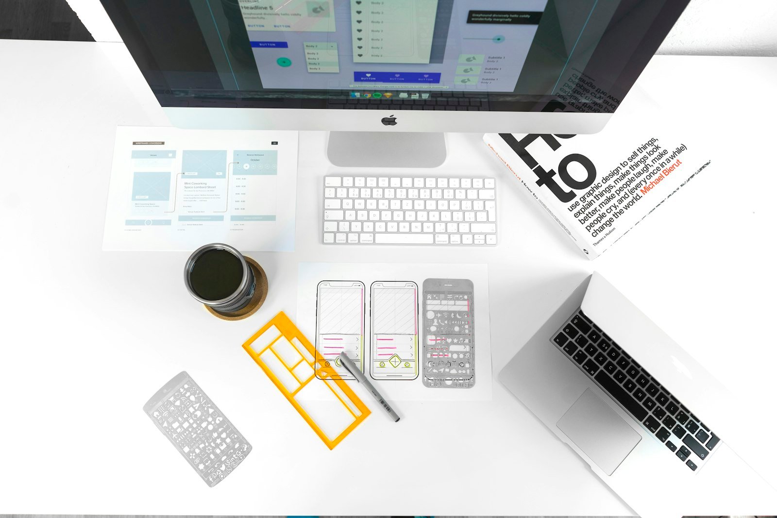 Web design and development workspace with laptop and desktop